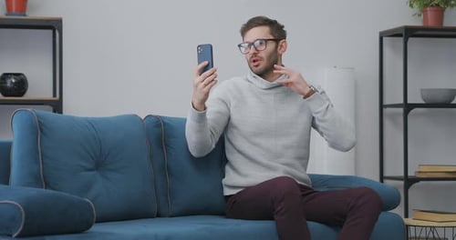 Young Adult Talking on Smartphone Video Call
