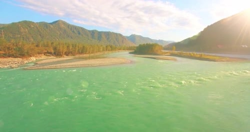 Low Altitude Flight Over Fresh Fast Mountain River with Rocks at Sunny Summer Morning
