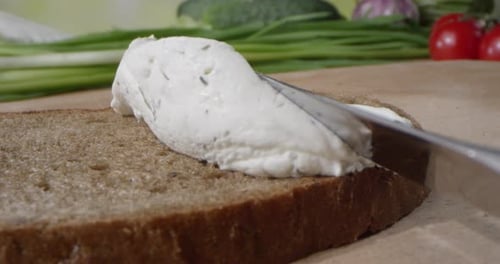 Spreading Creamy Cheese on Bread with Knife
