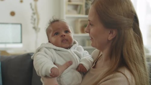 Loving Mother Cradling her Adorable Infant