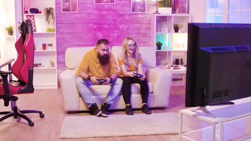 Couple Playing Video Games Together at Home