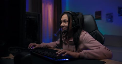 Girl Gaming on Computer at Home at Night