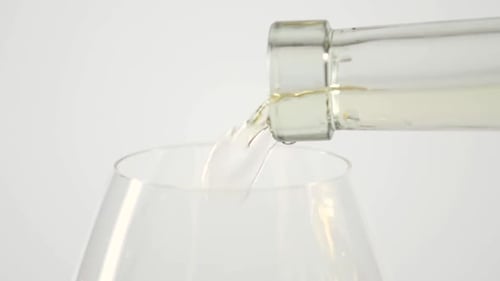Pouring White Wine into Glass Close Up