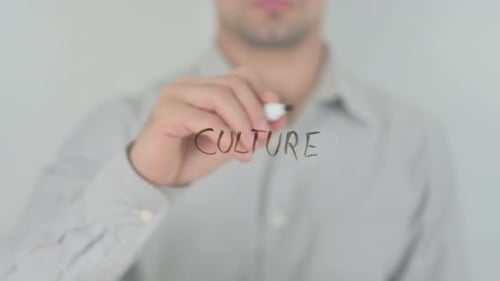 Man Writing Culture with Marker on Glass