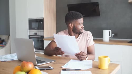Man Works on Laptop at Home