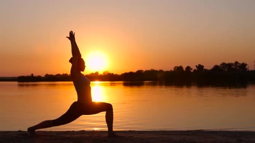 Silhouette Yoga on Beach at Golden Sunrise