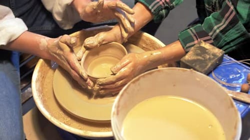 Boy and Woman Works with Pottery Wheel in a Workshop, Slow Motion