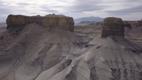 Aerial view flying past desert cliffs viewing landscape layers