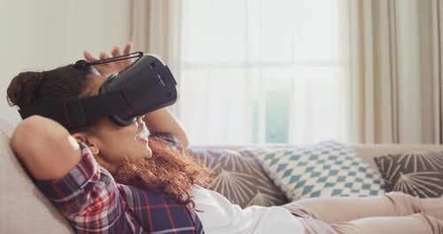 Woman Wearing VR Headset Relaxing on Couch