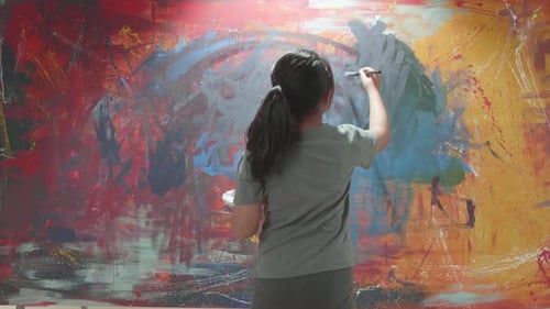 Young Artist Painting an Abstract Colorful Painting
