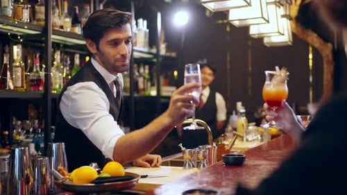 4K Male bartender talking and celebrating holiday event with woman customer at luxury bar.