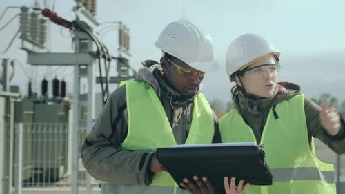 Electric Station Worker and Engineer Lady Discuss Project