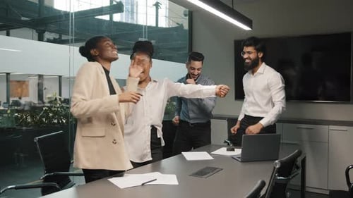 Motivated Multiracial Diverse Business Group Successful Team Dancing Celebrating Success in Office