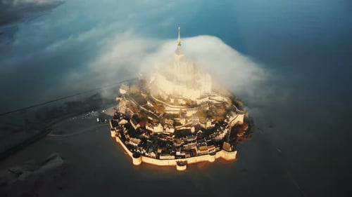 Top View Drone Flying High Around Majestic Sunrise Mont Saint Michel Island Castle with Cloud on Top