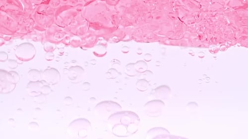 Vibrant Pink Bubbles Rising in Water
