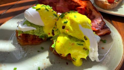 Breakfast Eggs Benedict with Bacon on Plate