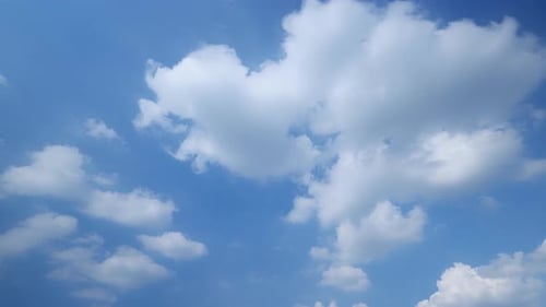 Drifting Cumulus Clouds in a Bright Blue Sky