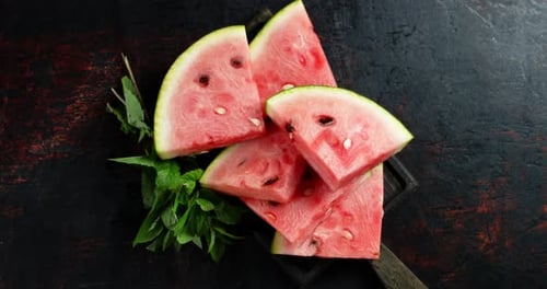 Slices of Watermelon on the Cutting Board Slowly Rotate.