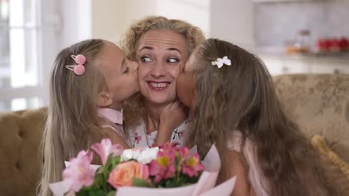 Daughters Give Flowers to Mother for Birthday
