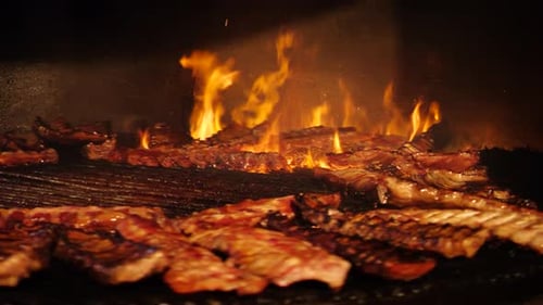 Ribs Sizzle Over Open Flames on Grill