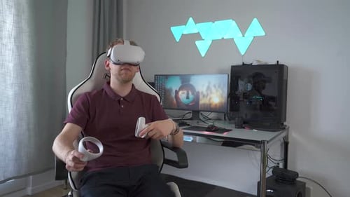 Man Wearing VR Headset in home office. Using Gestures with Hands.