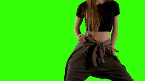 Mid section of woman dancing against green screen background