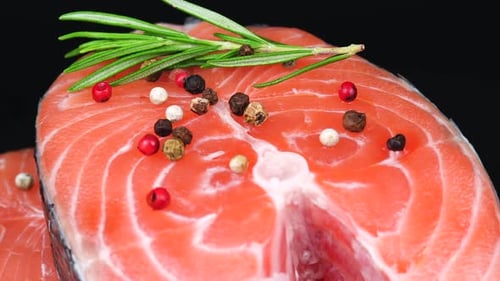 Close up Salmon Steak with Pepper and Rosemary