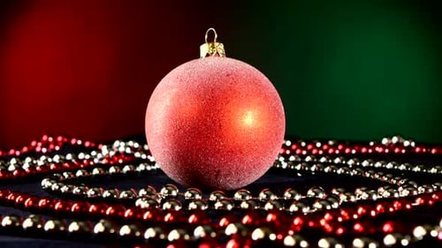 Shiny Red Toy for Christmas or New Year and Beads, Rotation, on Green
