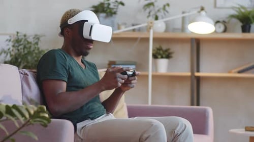 Man Smiles Wearing VR Headset Playing Video Game
