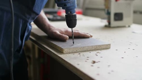 Drilling a Hole in Wood at a Workshop