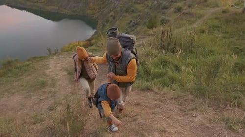 Family Hiking Adventure Along Grassy Lakeside Trail