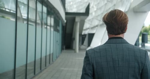 Rear Back View of Businessman Commuting to Work