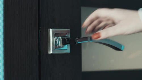 Woman's Hand Opens Door into Modern Home