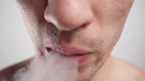 Man Vaping, Inhaling and Exhaling Vapor Close Up