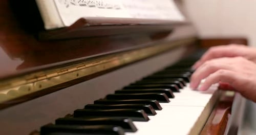 Man practicing piano at home