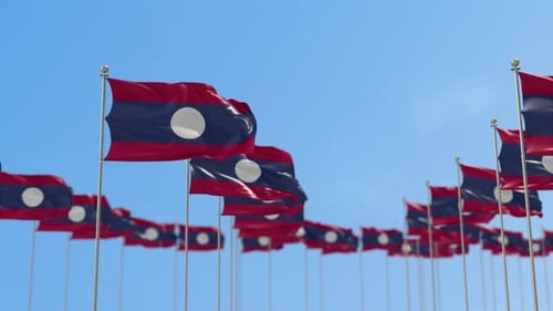Waving Laos Flags Against Clear Blue Sky Loop