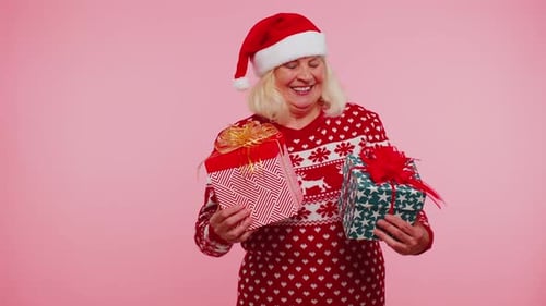 Senior Woman Holding Christmas Gifts and Smiling