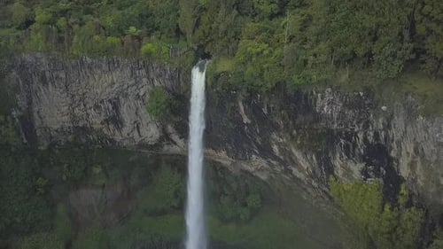 Waterfall Cascading Down Rocky Cliffside From Above