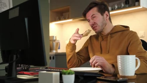 Tired Man Works Late at Workplace Use Computer