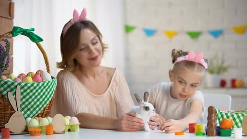 Woman and Child Celebrate Easter with a Rabbit