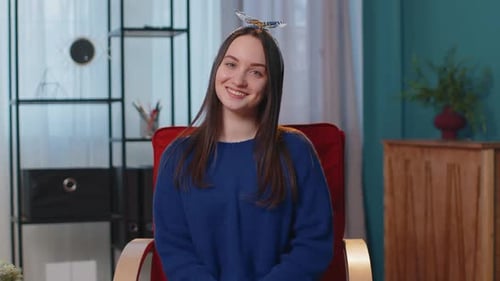 Young Woman Smiling in Red Chair Indoors