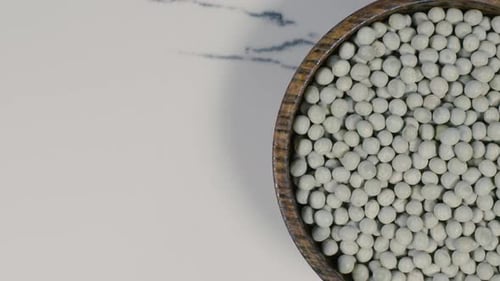 Dried Peas in Bowl on White Marble Surface