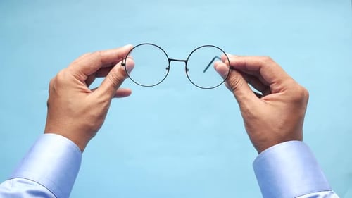 Close Up of Man Hand Holding Old Eyeglass