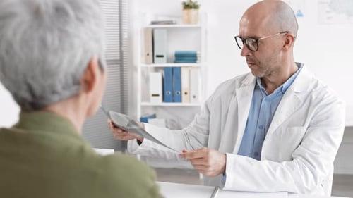 Doctor Checking X-rays at Appointment