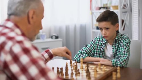 Young Boy Playing Chess With Grandfather, Family Traditions, Mind Development