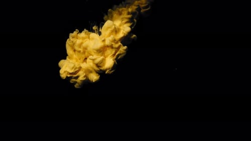Yellow Ink Expanding in Black Background
