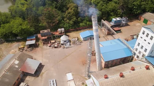 Slow Motion Aerial Shot of Demolition of Old Industrial Brick Pipe at the Factory