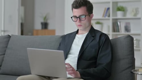 Man Working on Laptop From Home