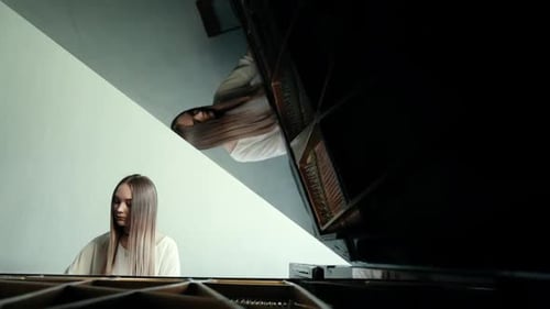 Young Woman Plays Grand Piano at Home