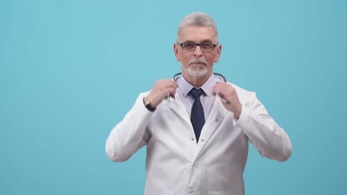 Serious Doctor Puts on Stethoscope and Crosses Arms